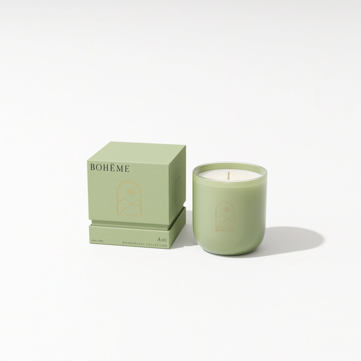 Sage green frosted glass candle with cream wax and matching cube box featuring gold archway emblem and BOHÈME text