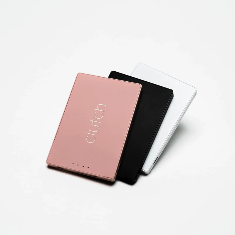 Three slim portable chargers in rose gold, black, and white with Clutch branding and LED indicator dots stacked together