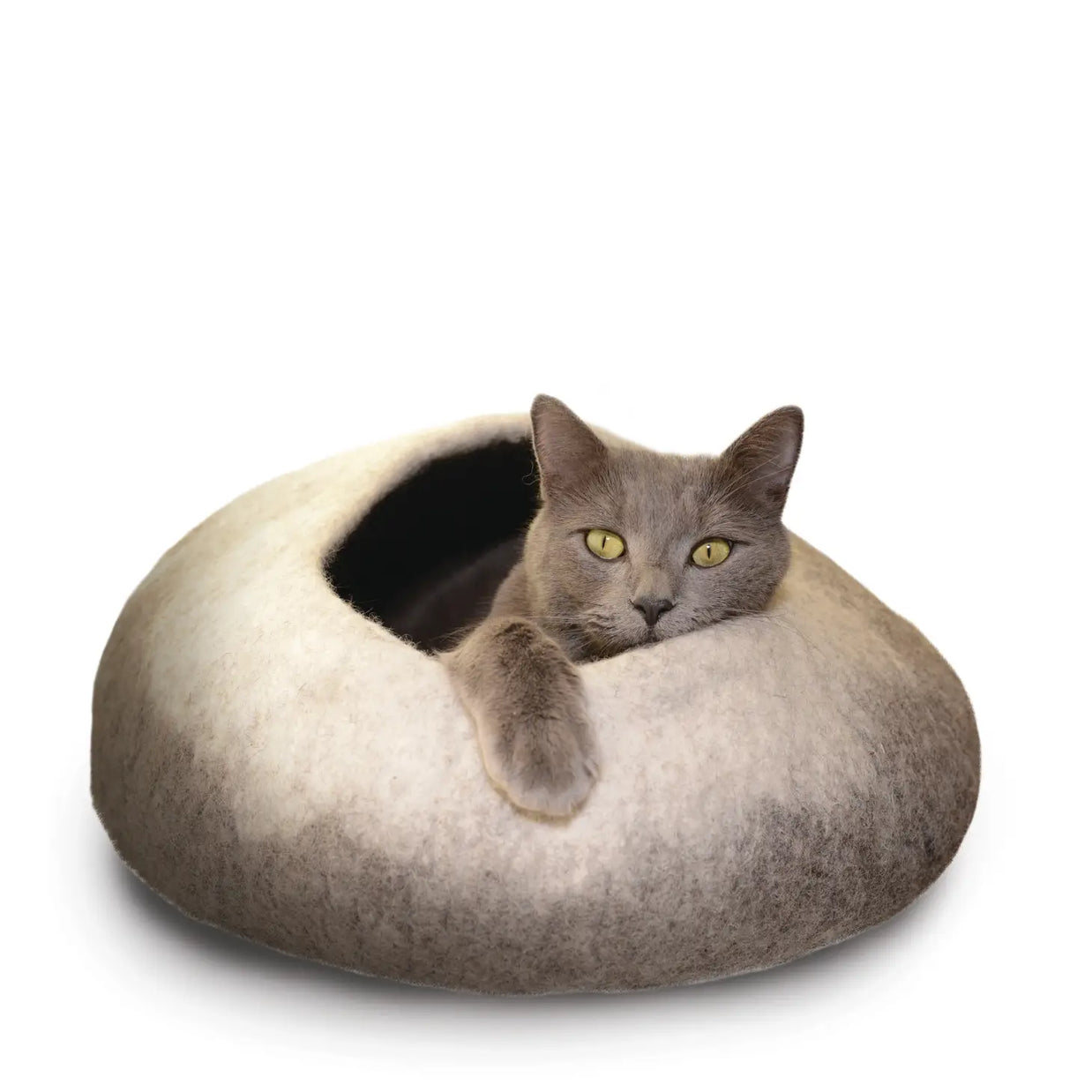 Natural ombre felted wool cat cave bed with rounded dome shape and side opening, gray cat relaxing inside with paw draped over edge