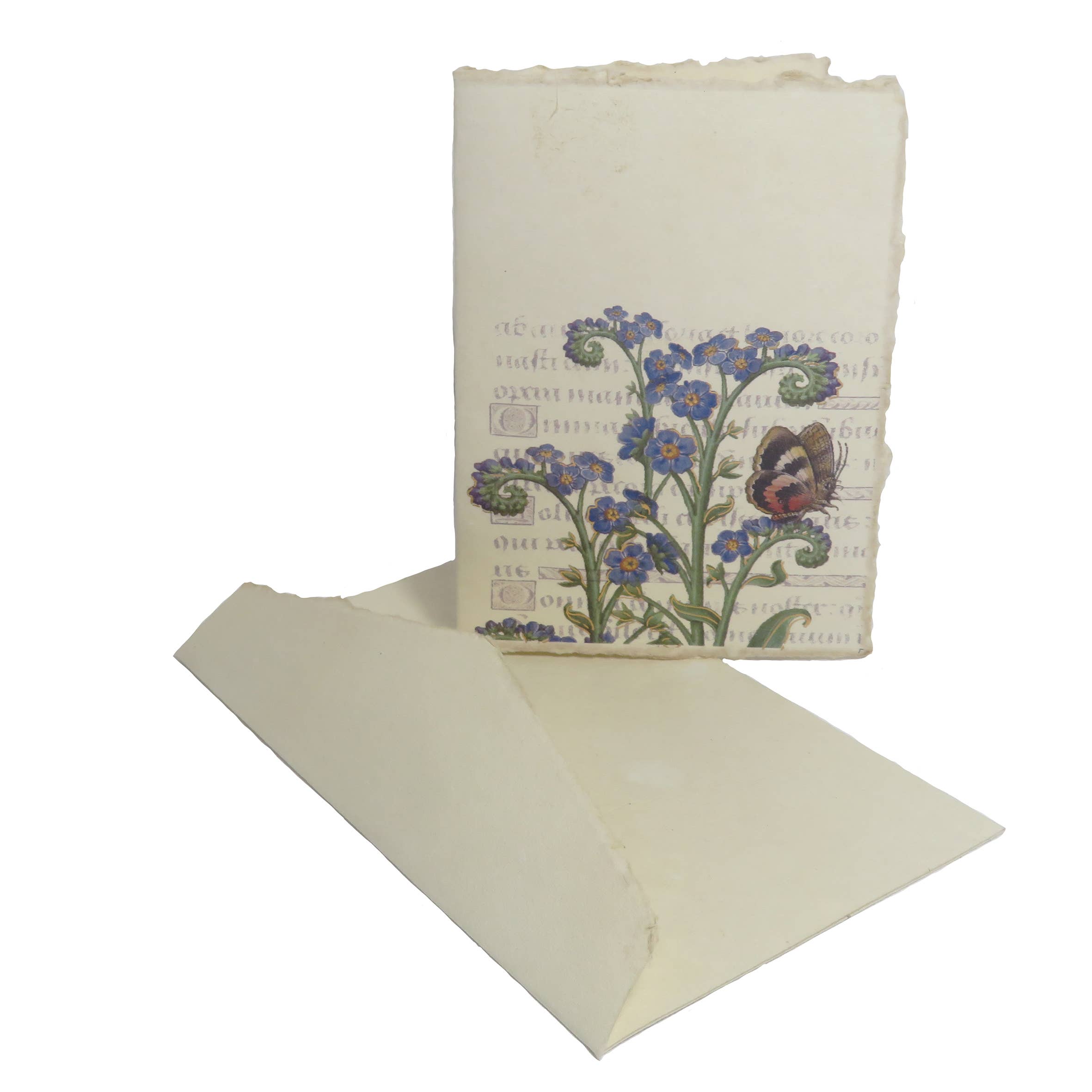 Notebook with floral design and butterfly on cover, placed on a matching cream-colored paper.