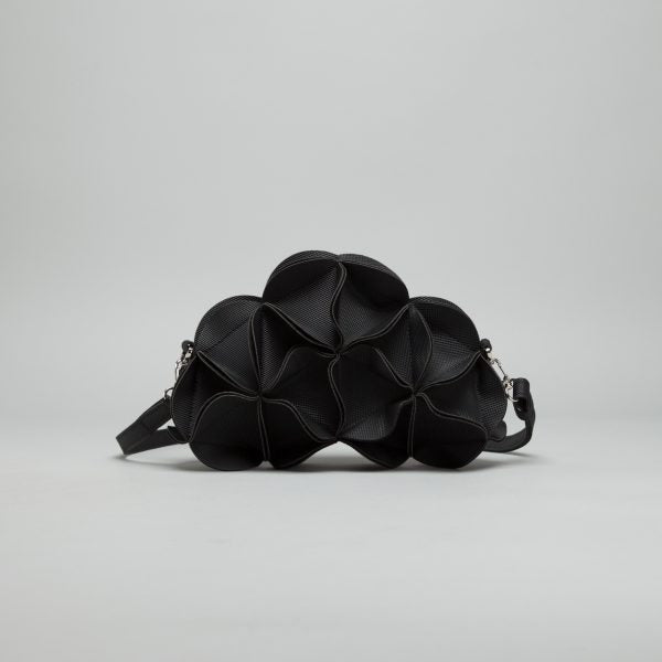 Black leather sculptural shoulder bag with ruffled petal-like texture and adjustable crossbody strap with silver hardware