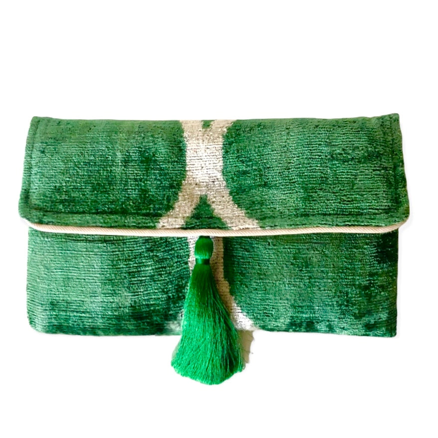 Emerald green sequined clutch with silver stripe pattern and bright green tassel detail centered on fold-over flap