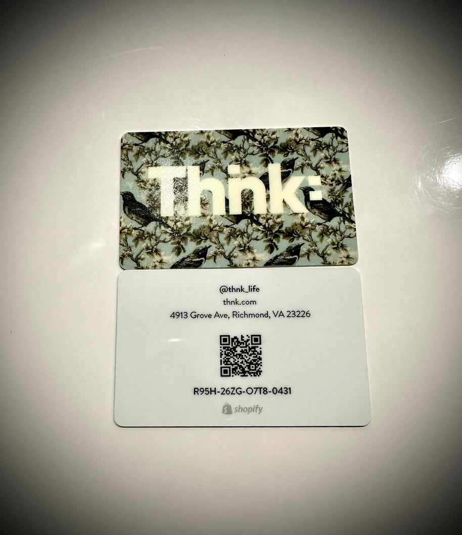 A plastic gift card with a camouflage pattern and the brand name 'Thnk' displayed prominently in the center.