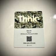 A plastic gift card with a camouflage pattern and the brand name 'Thnk' displayed prominently in the center.