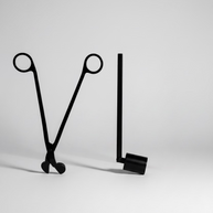 Two black metal tools on a marble surface