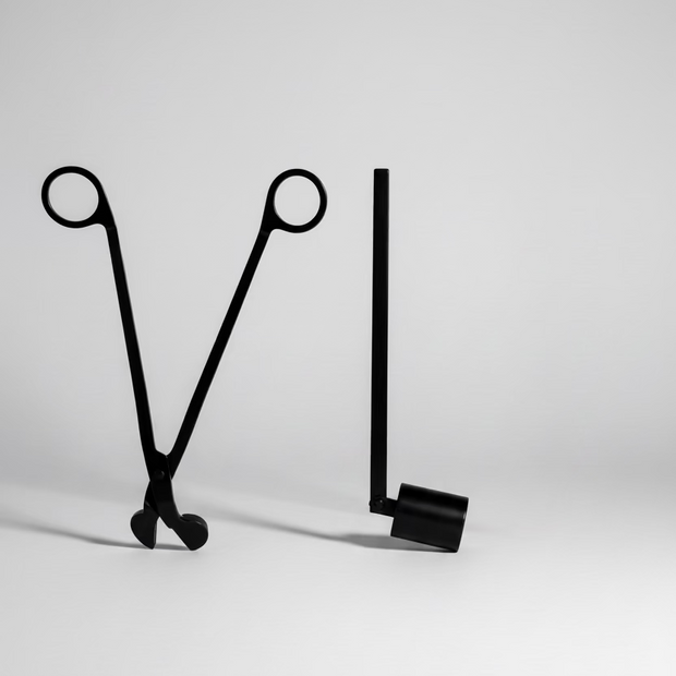 Two black metal tools on a marble surface
