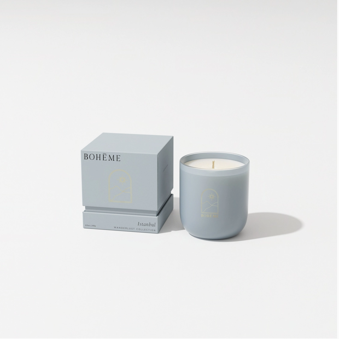 Pale blue-gray ceramic candle in matte finish with wooden wick and matching square gift box labeled Bohème Istanbul