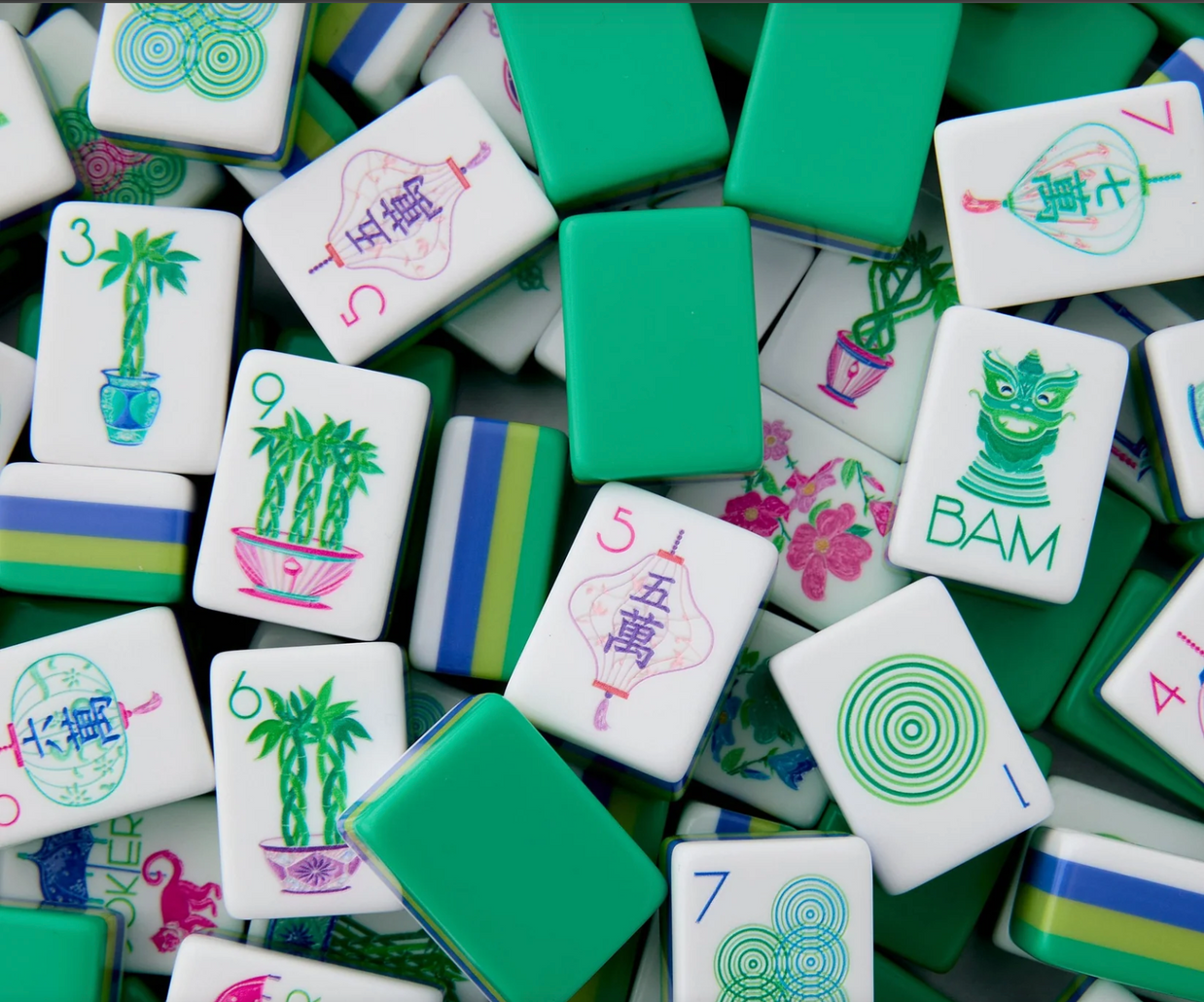 Mahjong tiles in white and mint green with colorful bamboo, flower, and circle symbols in pink, green, and blue designs