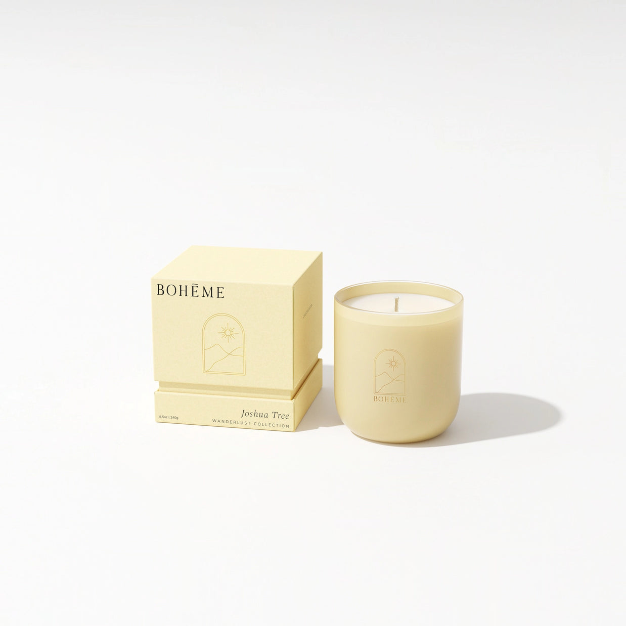 Pale yellow frosted glass candle with matching gift box featuring Joshua Tree Boheme Wanderlust Collection branding