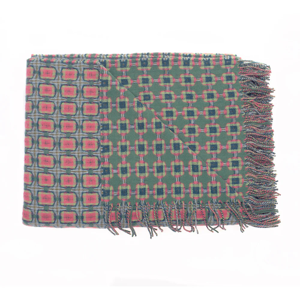 Woven wool throw blanket in sage green with pink and navy geometric squares pattern and twisted fringe edges