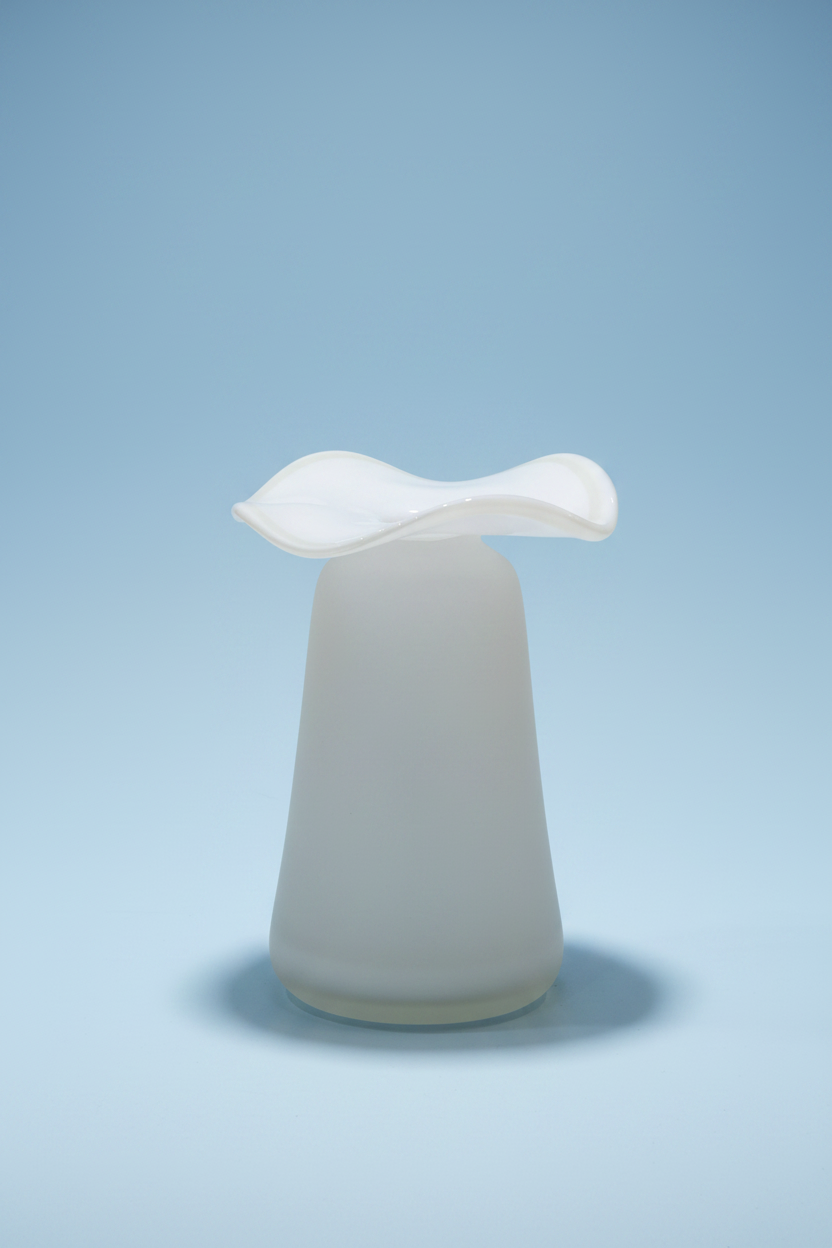 Opalescent white glass vase with tapered cylindrical base and ruffled petal-shaped rim in translucent finish