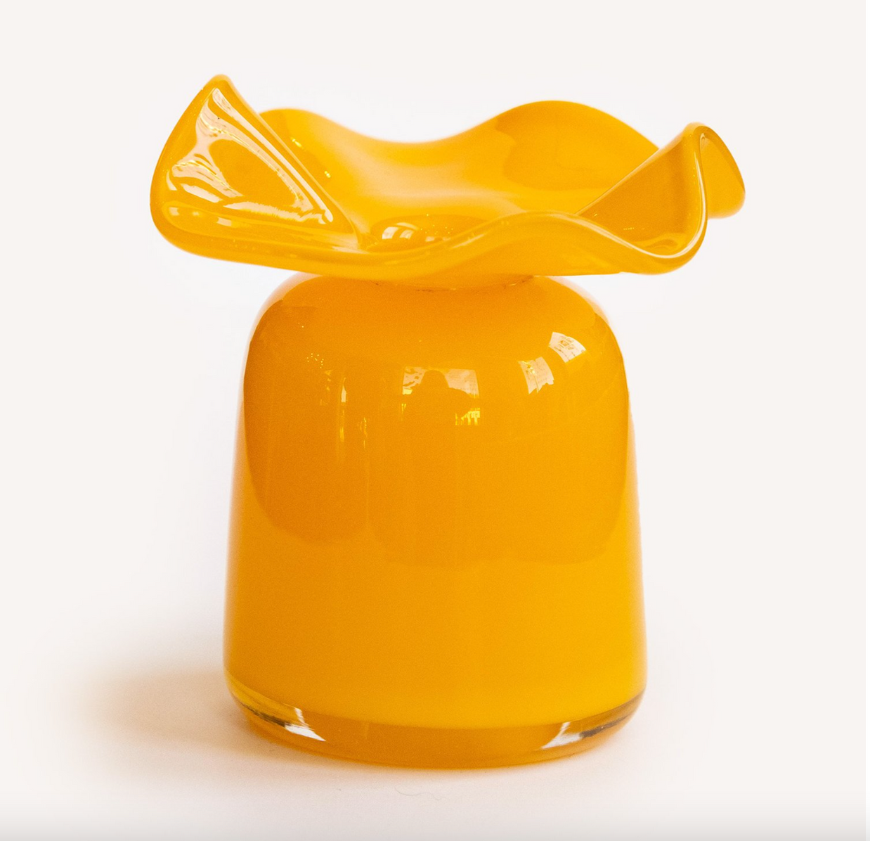 Blown glass vase in bright amber yellow with rounded base and organic ruffled rim with flowing undulating edges