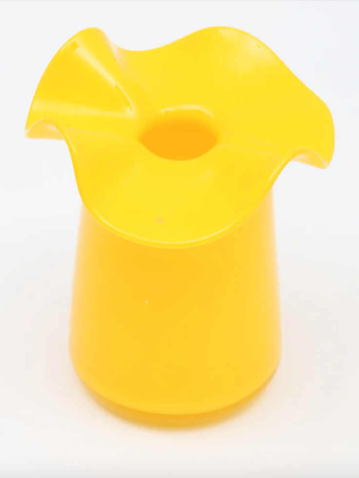 Bright yellow translucent glass vase with ruffled wavy rim and cylindrical base on white background
