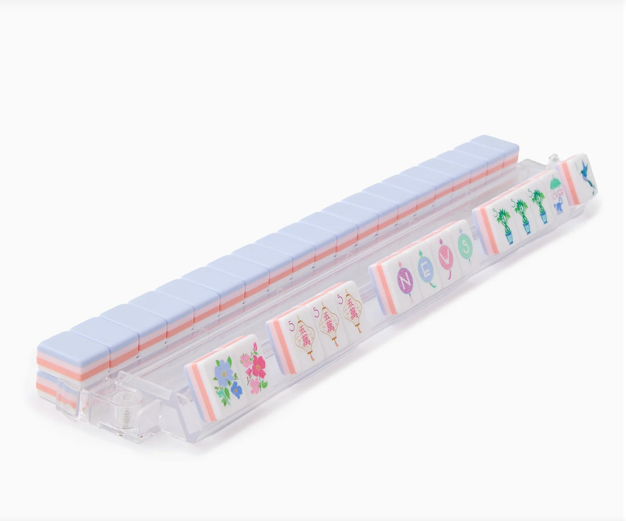 Clear plastic pill organizer with pale blue lid displaying colorful floral and cactus illustrations on compartments