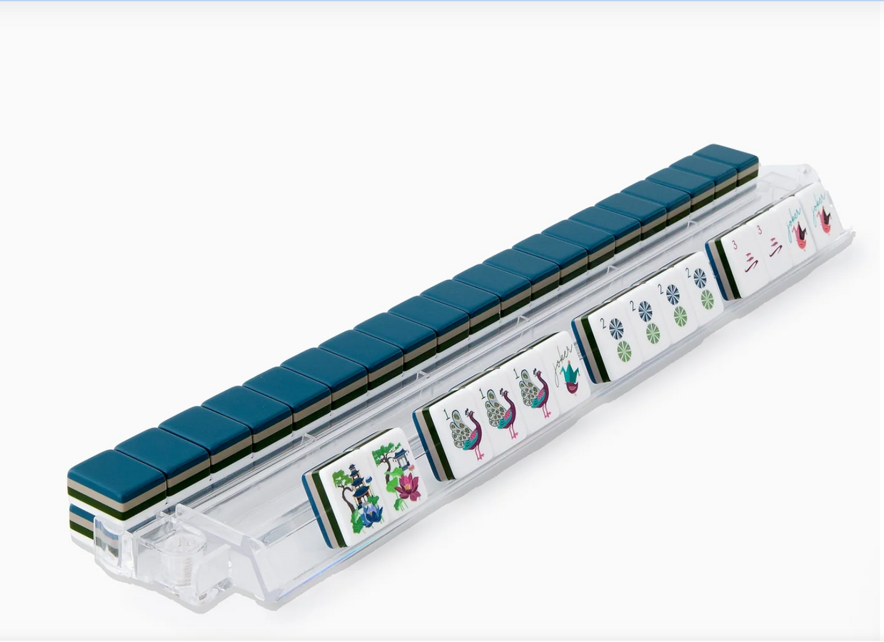 Mahjong set with teal padded pushers and clear acrylic tile racks displaying colorful floral bamboo character tiles