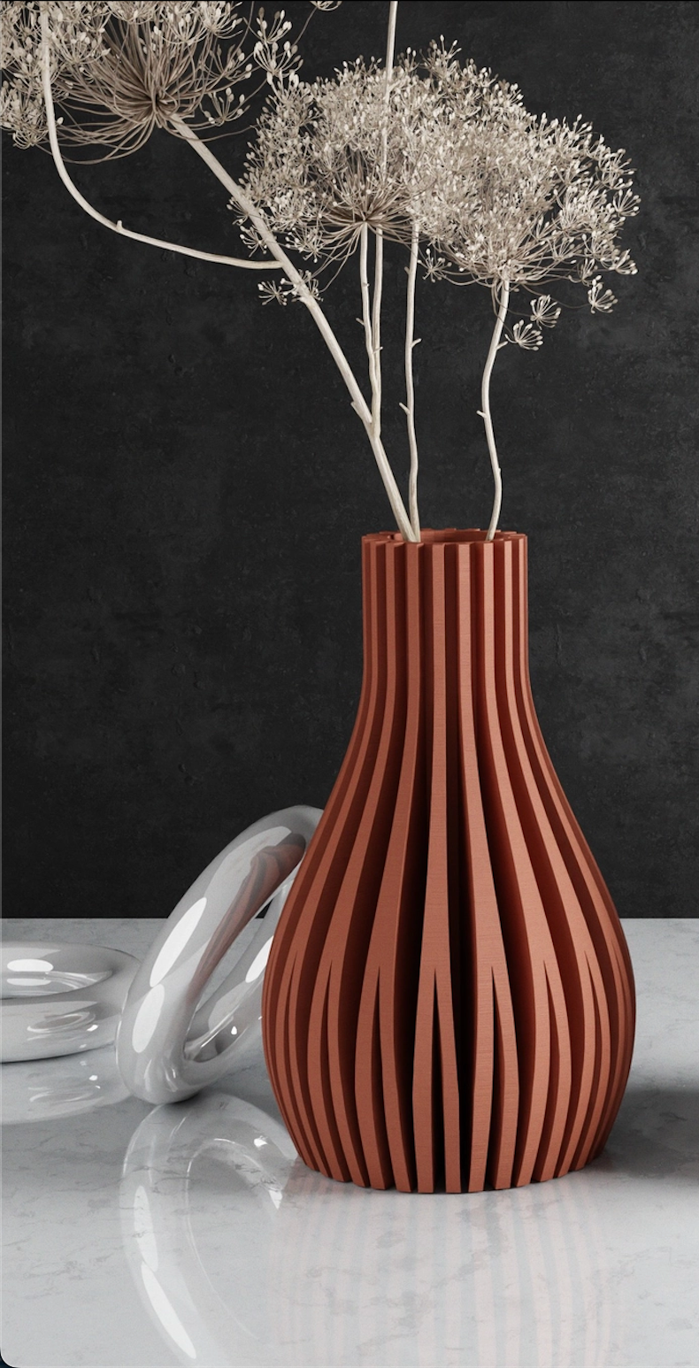 Terracotta vase with vertical ribbed texture holding dried white Queen Anne's lace stems against dark background