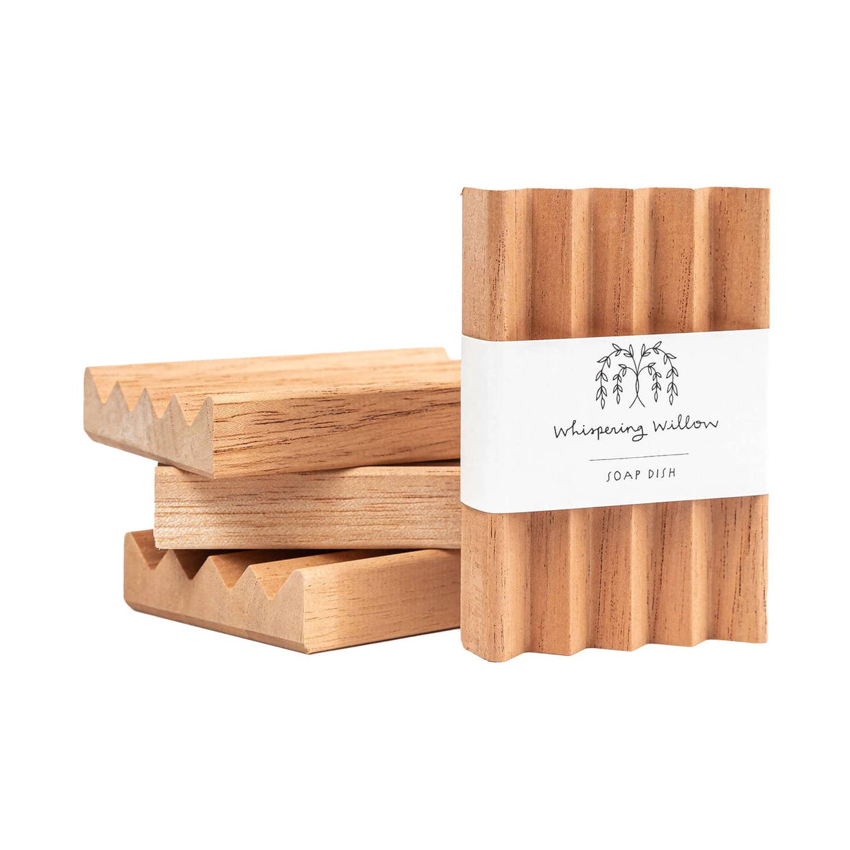 Natural wood soap dish with ridged surface and drainage grooves, displaying Whispering Willow branding label on wrapper