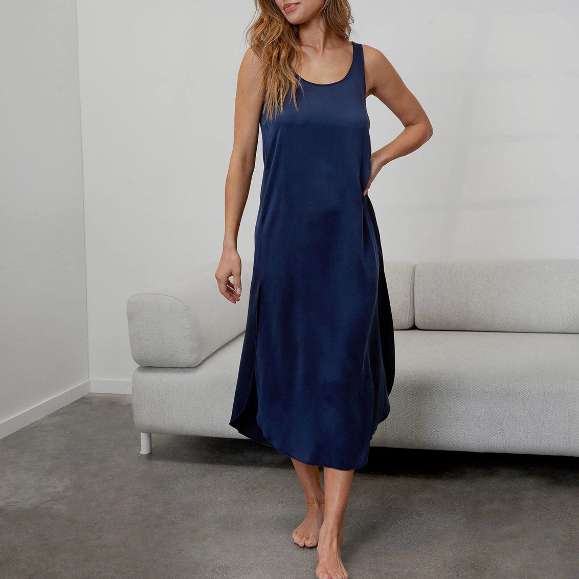 Navy blue sleeveless midi dress with scoop neckline and relaxed A-line silhouette in smooth flowing fabric