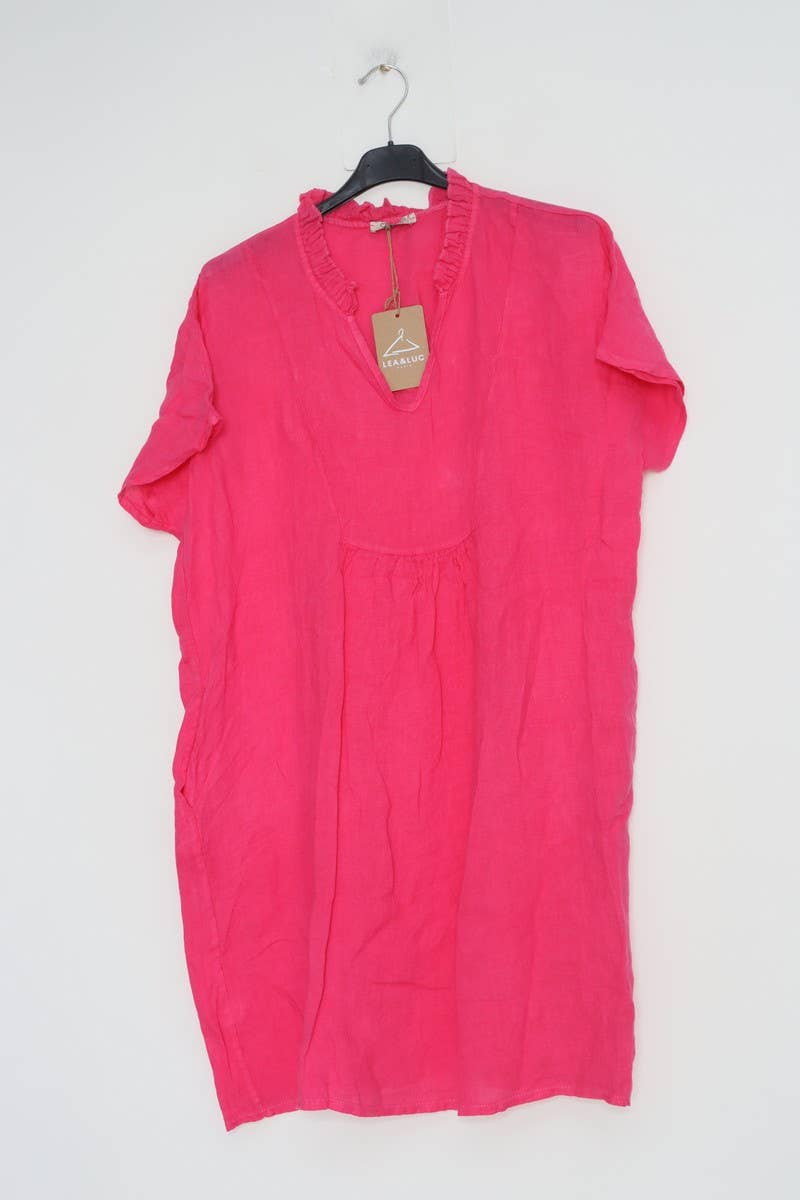 Hot pink linen tunic dress with ruffled v-neck, short sleeves, gathered waist, and tan brand tag on black hanger