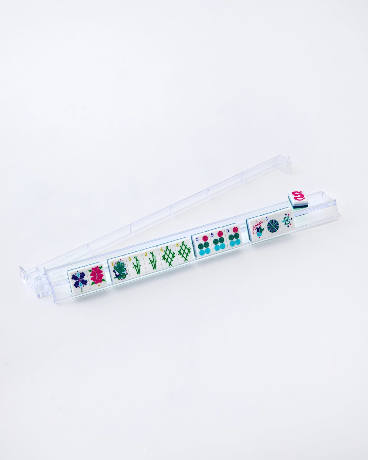 Clear acrylic mahjong tile rack with colorful game tiles featuring flowers, bamboo, dots and character symbols