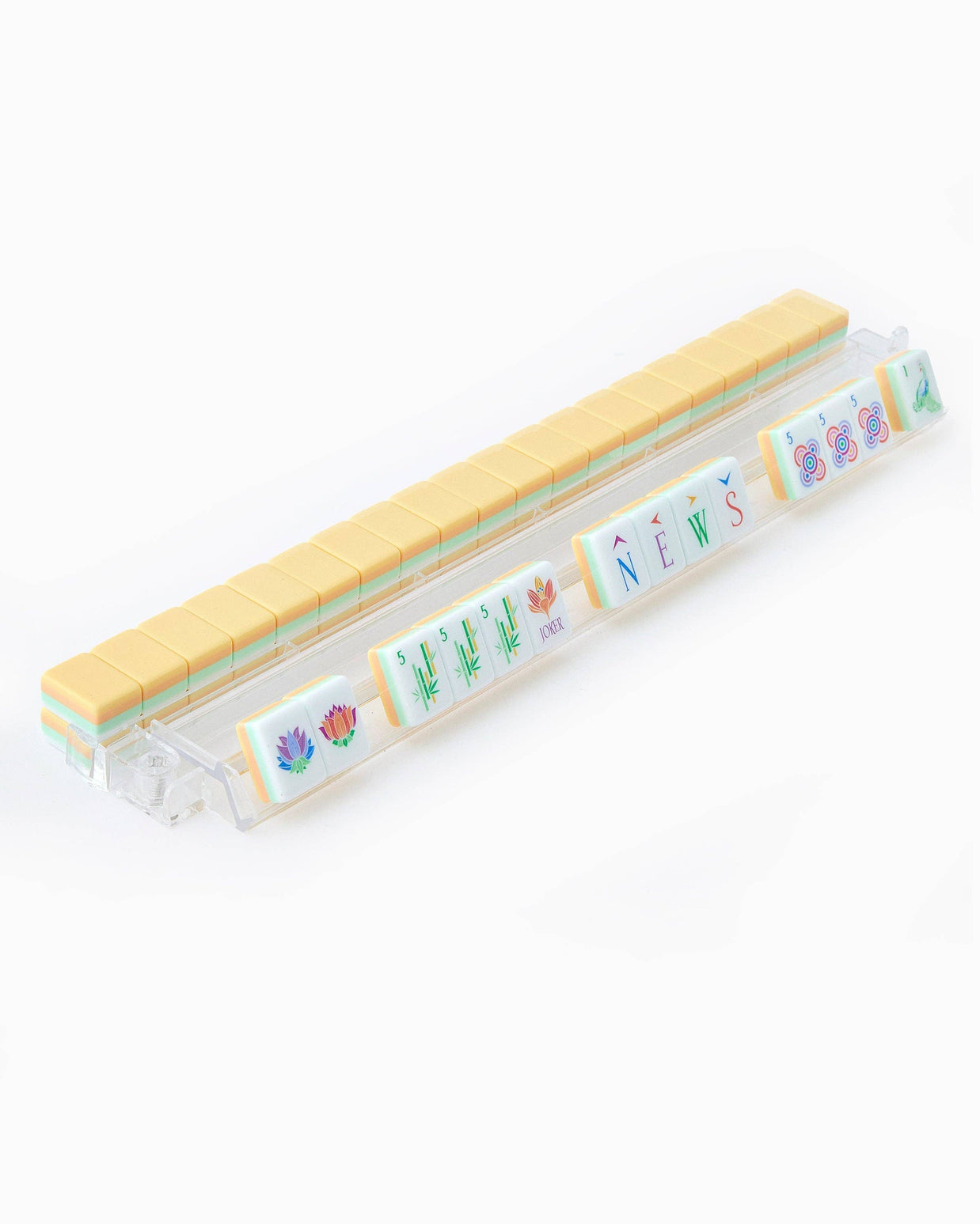 Clear plastic travel toothbrush case with yellow ridged cap and colorful botanical illustrations including flowers and news text