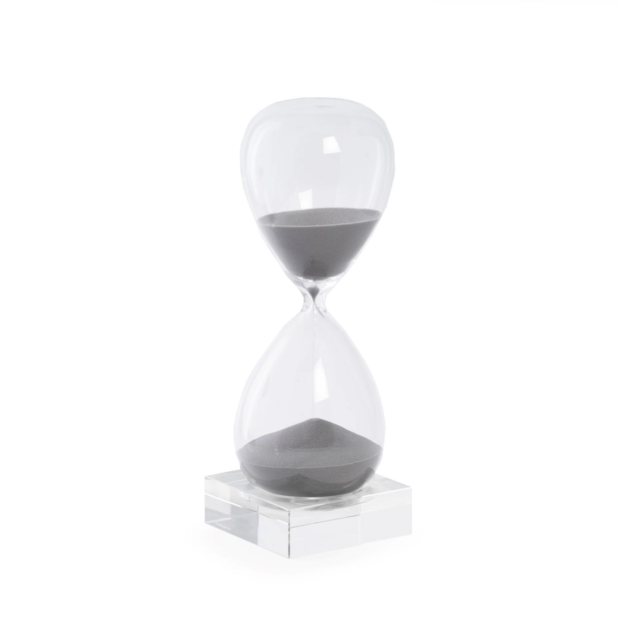 Clear glass hourglass timer with gray sand on transparent acrylic base against white background
