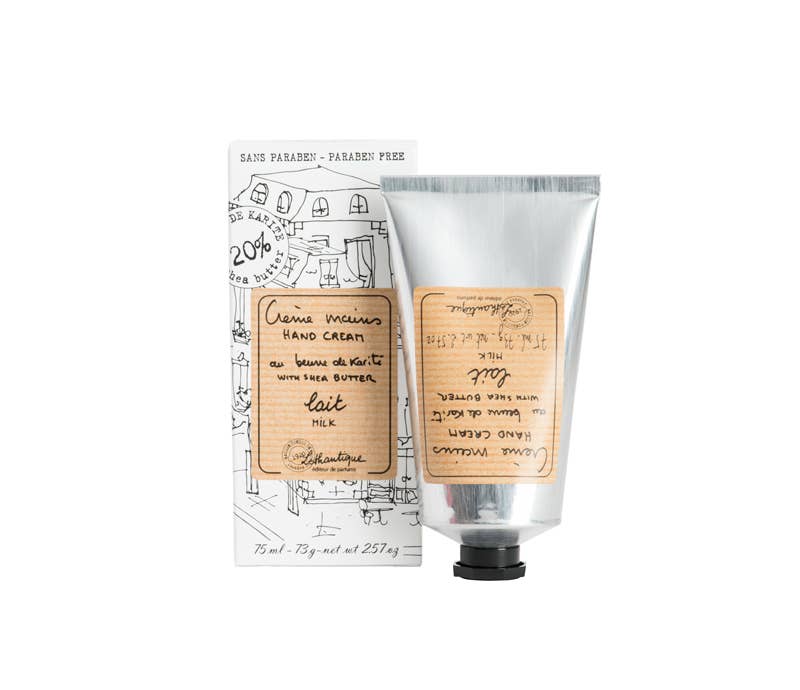 Silver hand cream tube with kraft paper label and illustrated cardboard packaging featuring French cottage sketch design