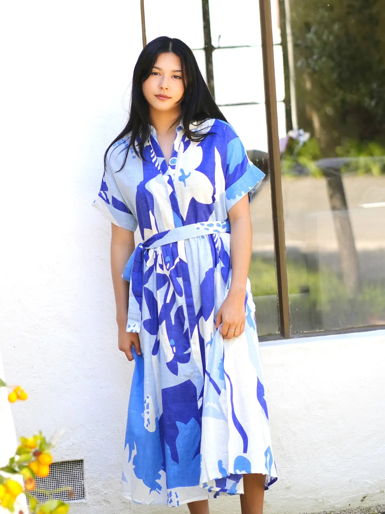 Blue and white abstract print midi dress with short sleeves, collared neckline, and matching fabric belt at waist