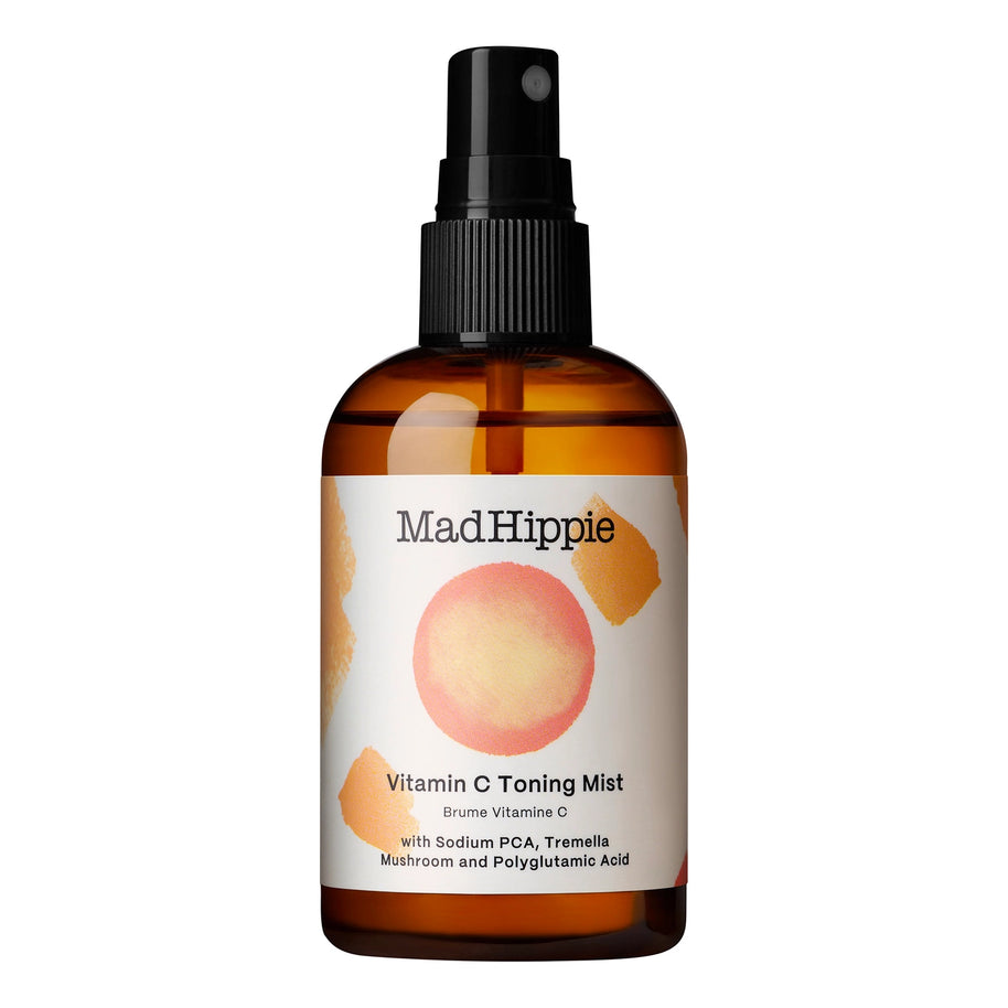 Amber glass spray bottle with black pump top and white label featuring coral watercolor circle design for Vitamin C toning mist