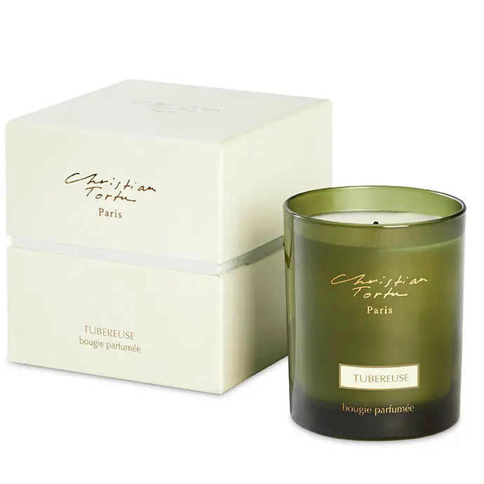 Green gradient glass candle with cream-colored wax, gold Christian Tortu Paris branding, and ivory packaging box with Tubereuse label