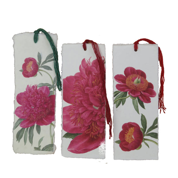 Three floral bookmarks with tassels on a white background