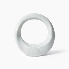 White marble circular sculpture with hollow center and natural gray veining throughout smooth polished surface