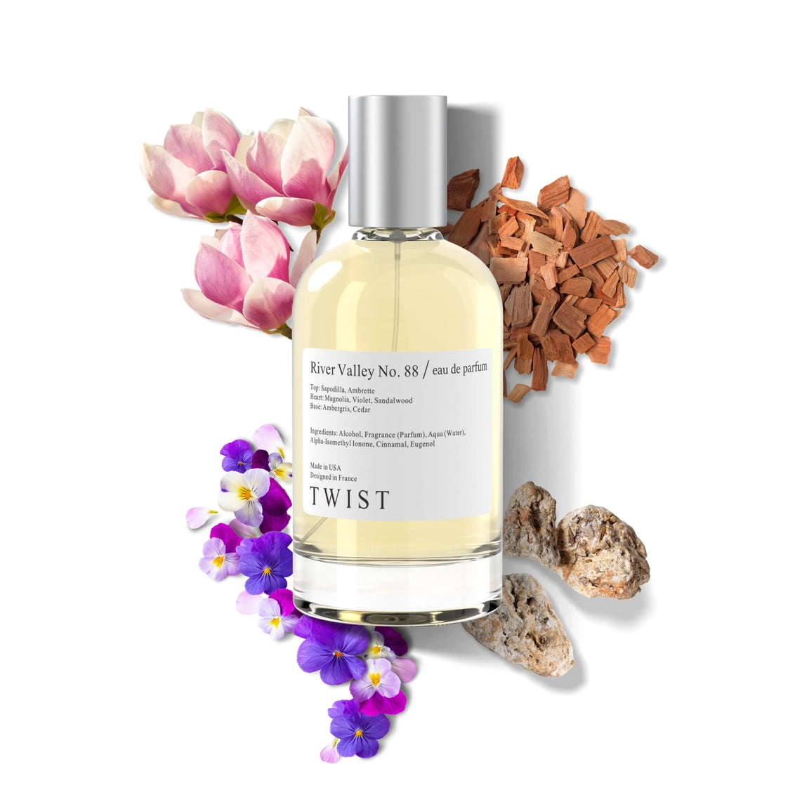 Twist eau de parfum bottle with silver cap surrounded by pink magnolia blooms, purple pansies, sandalwood chips, and stones