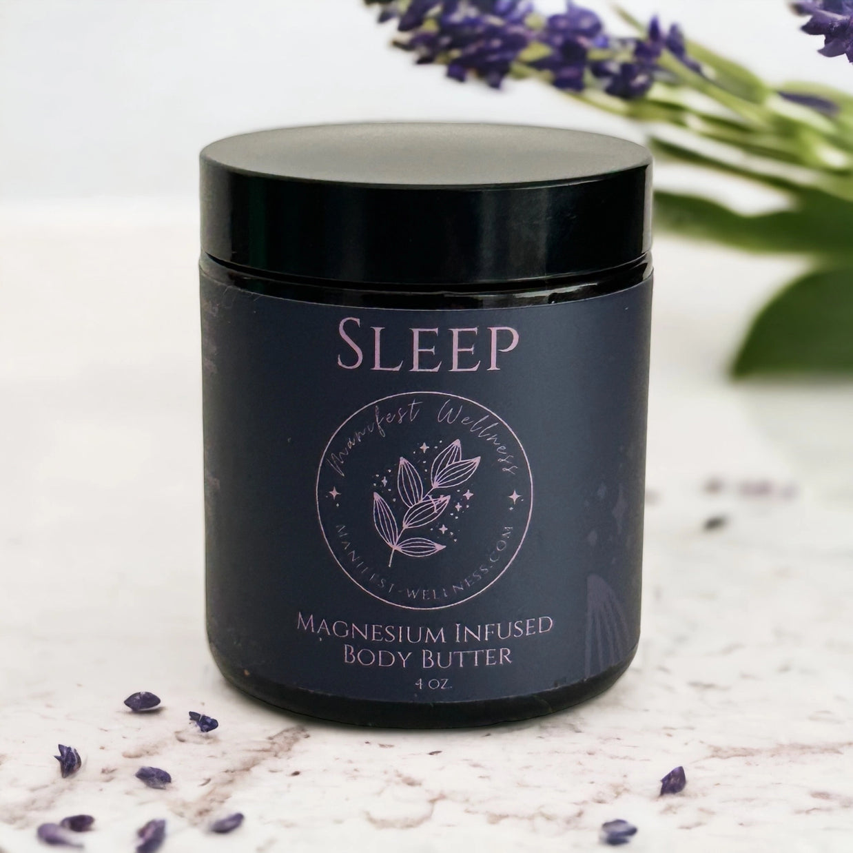 Dark navy glass jar with black lid labeled Sleep magnesium infused body butter with botanical wreath design in mauve pink