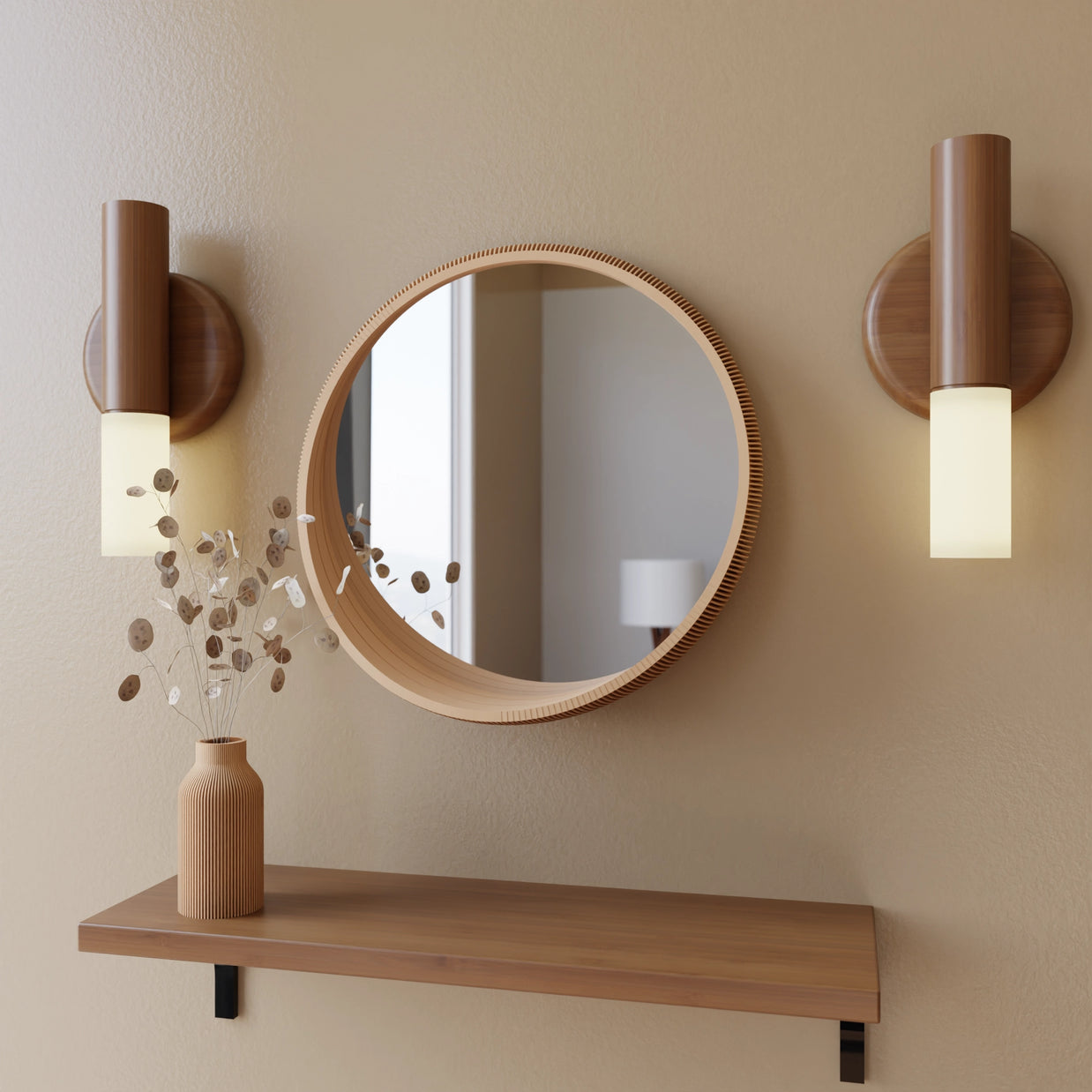 Round wood-framed mirror with ridged edge flanked by walnut cylinder sconces with frosted glass shades on beige wall