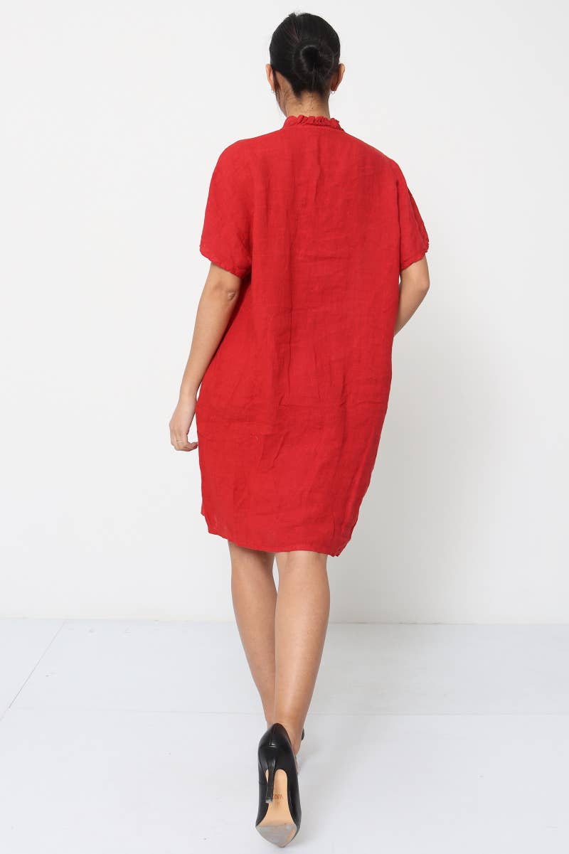 Bright red linen tunic dress with gathered mock neck, short sleeves, and relaxed knee-length silhouette, back view