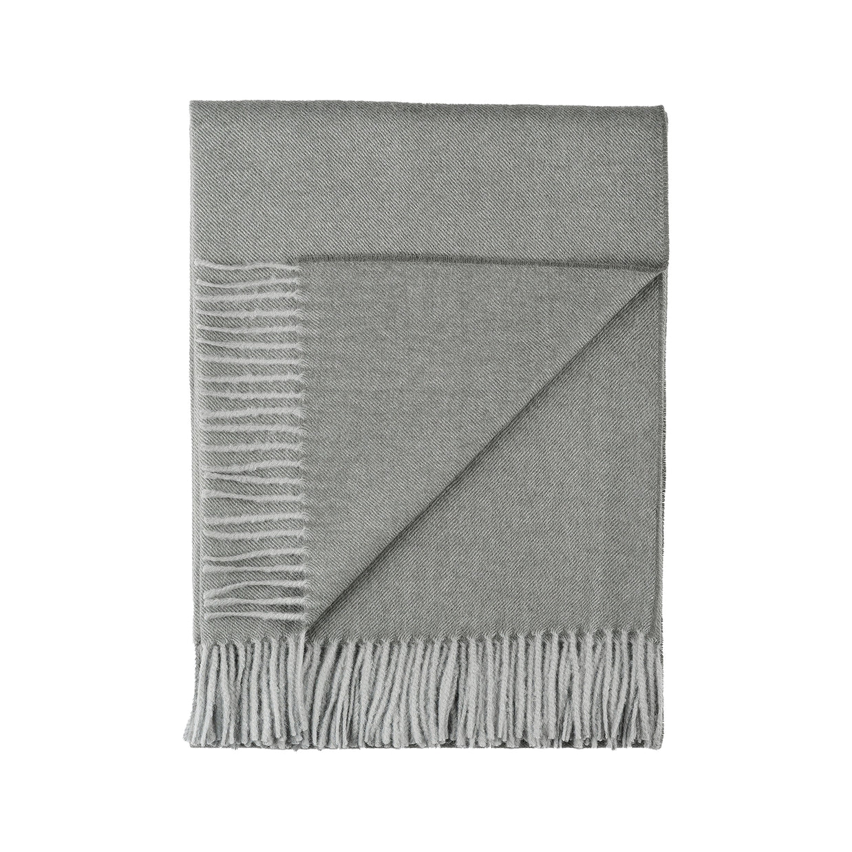 Gray herringbone baby alpaca throw blanket with twisted fringe detail along bottom edge, folded to show diagonal weave pattern