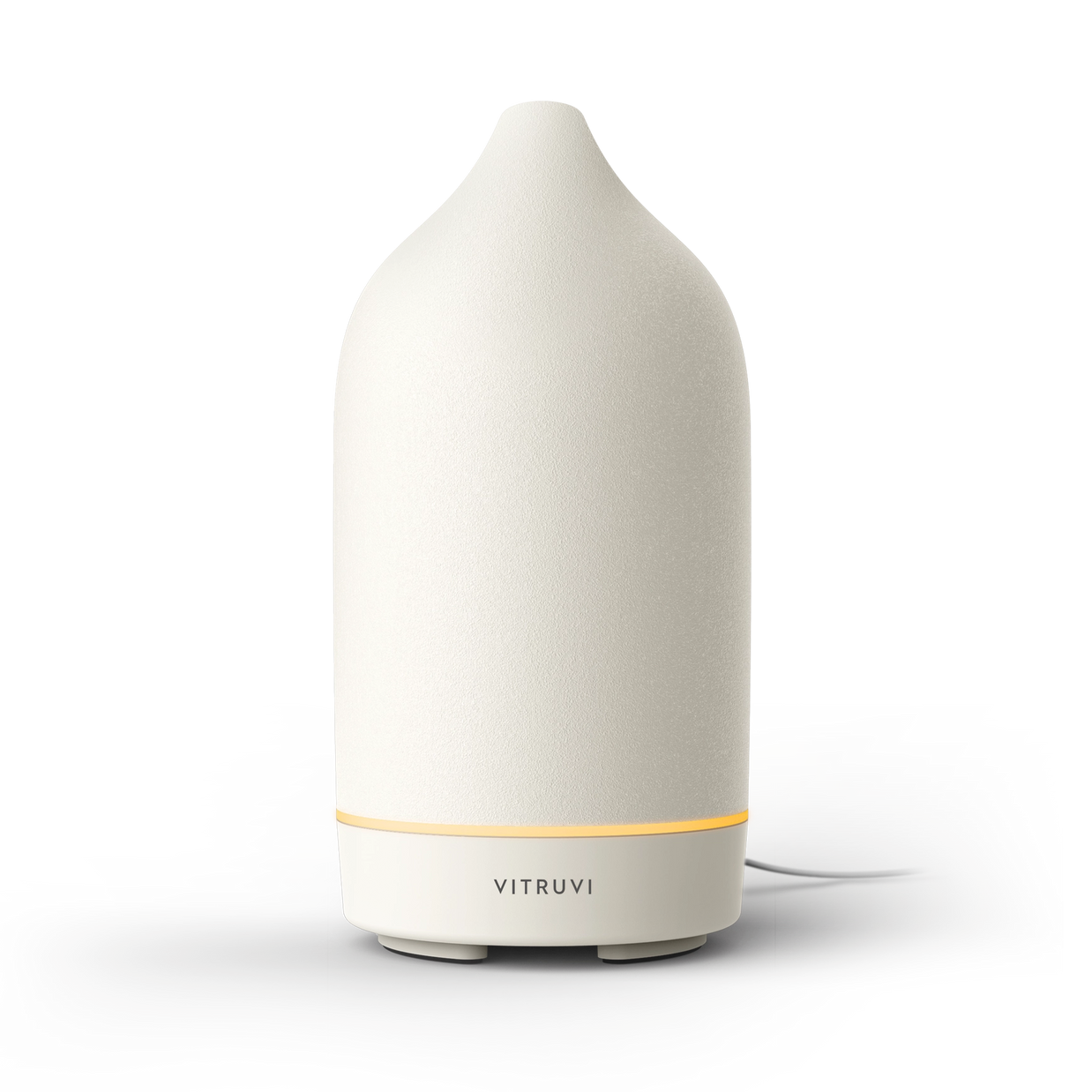 White ceramic dome-shaped essential oil diffuser with textured matte finish and glowing amber light ring at base