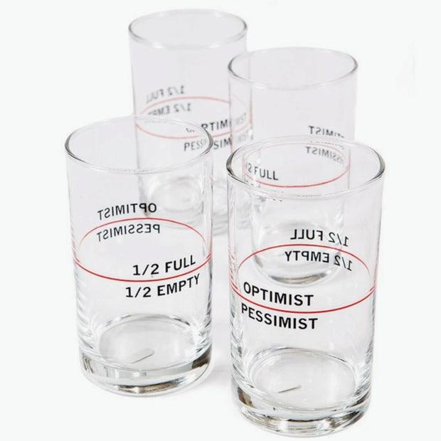 Clear glass tumblers with black text and red lines showing optimist/pessimist and half full/half empty measurements