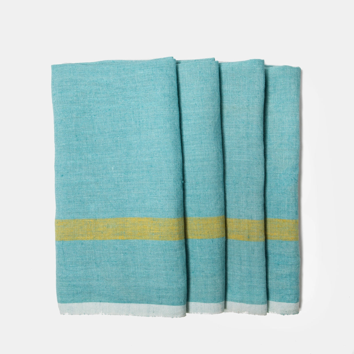 Four aqua blue linen napkins with yellow and white striped borders folded and stacked on light background