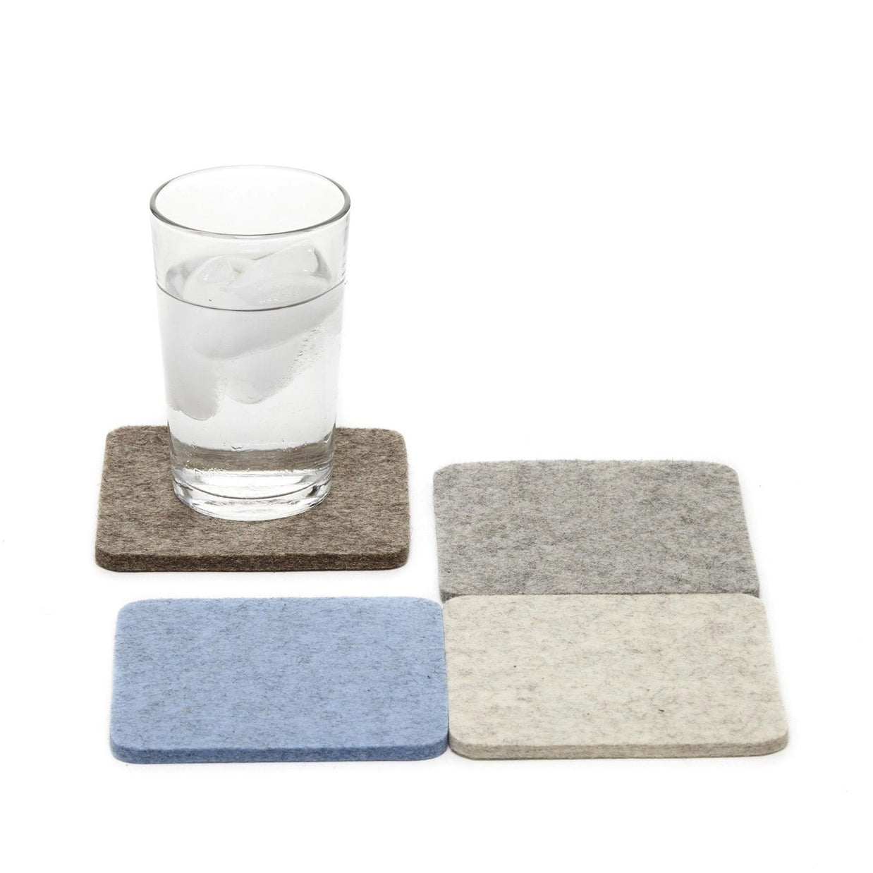 Square felt coasters in brown, light gray, periwinkle blue, and cream with glass of water on white background