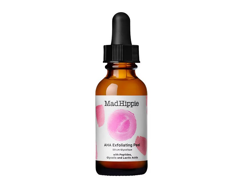 Amber glass dropper bottle with black cap, white label featuring pink watercolor circles and MadHippie AHA Exfoliating Peel text