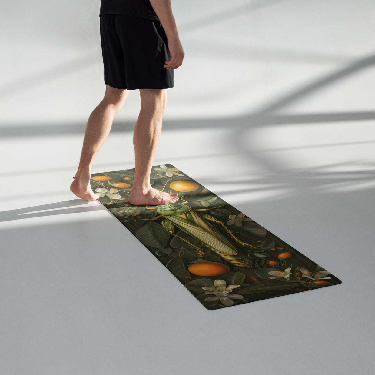 Dark green yoga mat with vintage botanical print featuring oranges, leaves, corn and flowers in earth tones