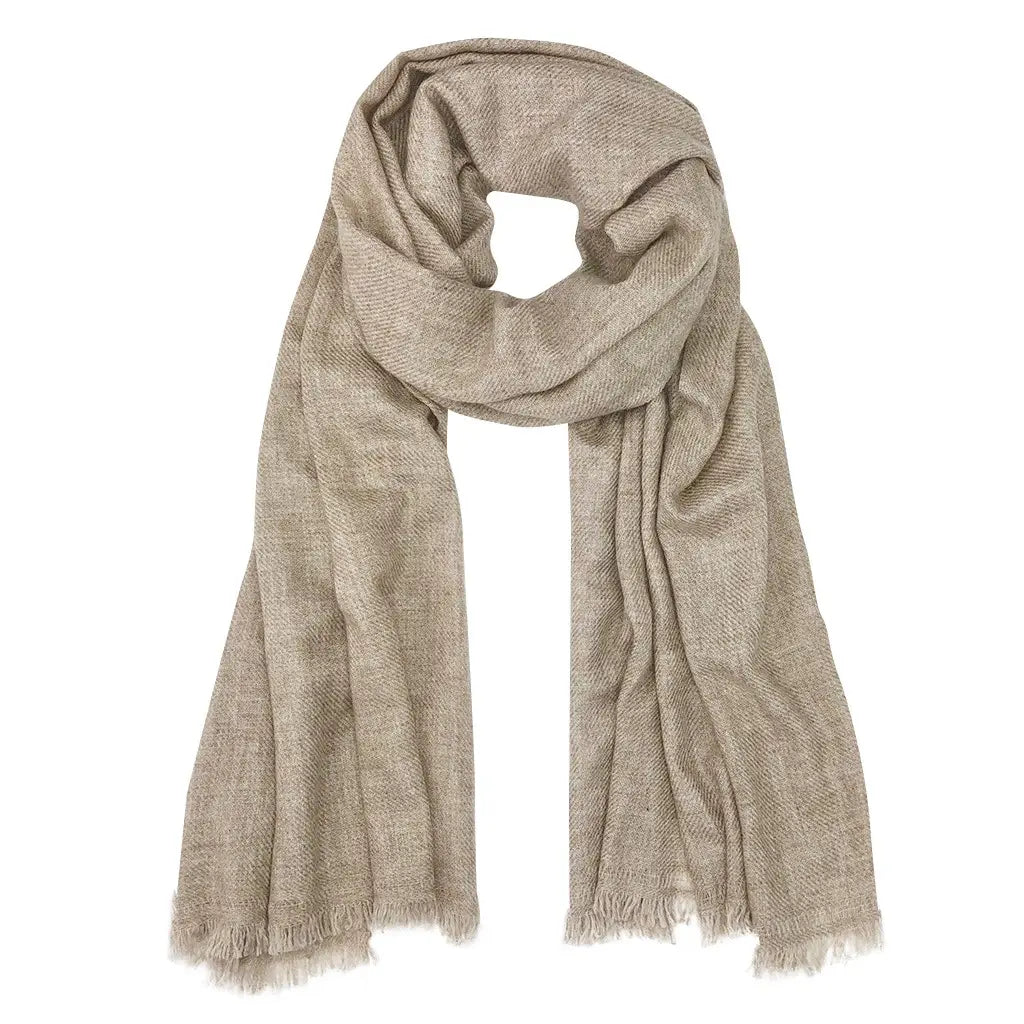 Beige cashmere scarf with diagonal textured weave pattern and raw frayed edges, draped to show soft flowing fabric